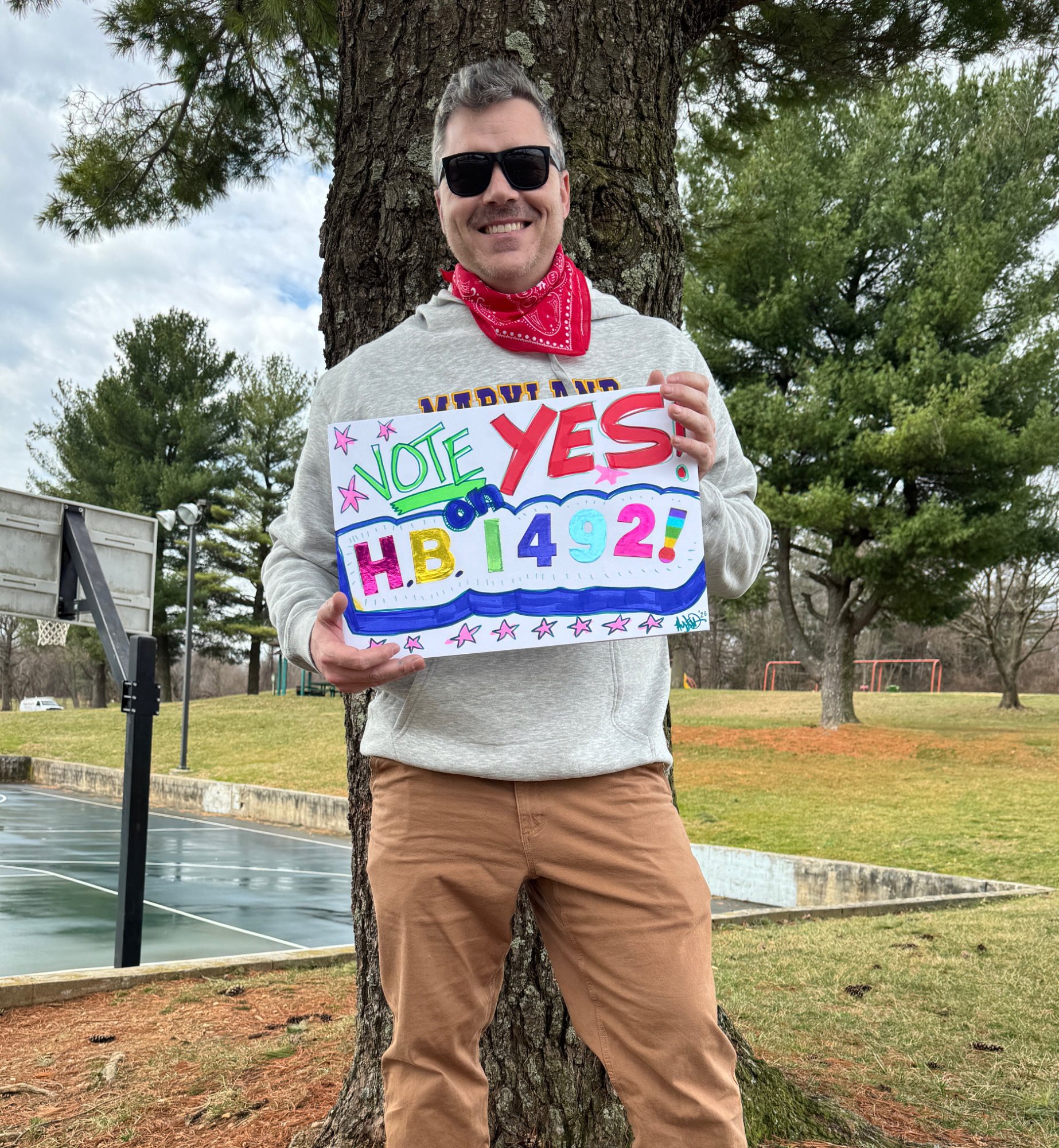 Austin Dyches holding Vote YES on HB 1492 sign